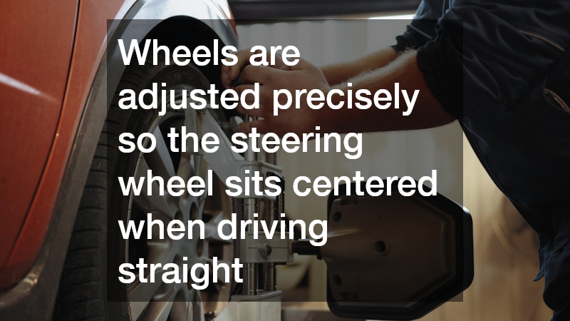 mechanic performing a wheel alignment on a car